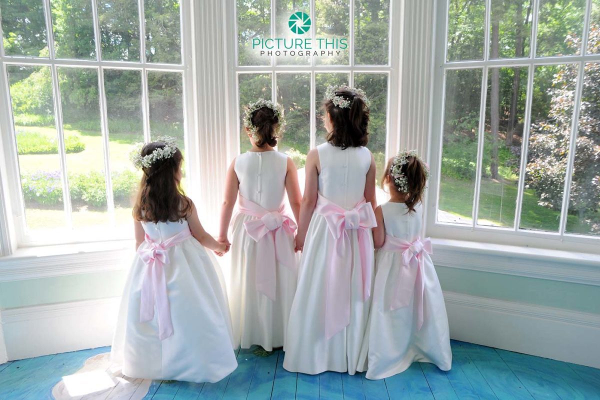 Immaculate Alumni Wedding Photos wedding-photographs-of-four-little-girls-holding-hands-lookout-out-lilly-pond-window