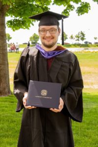 Tarrywile Staff Member Graduates zach-holding-diploma-in-cap-gown