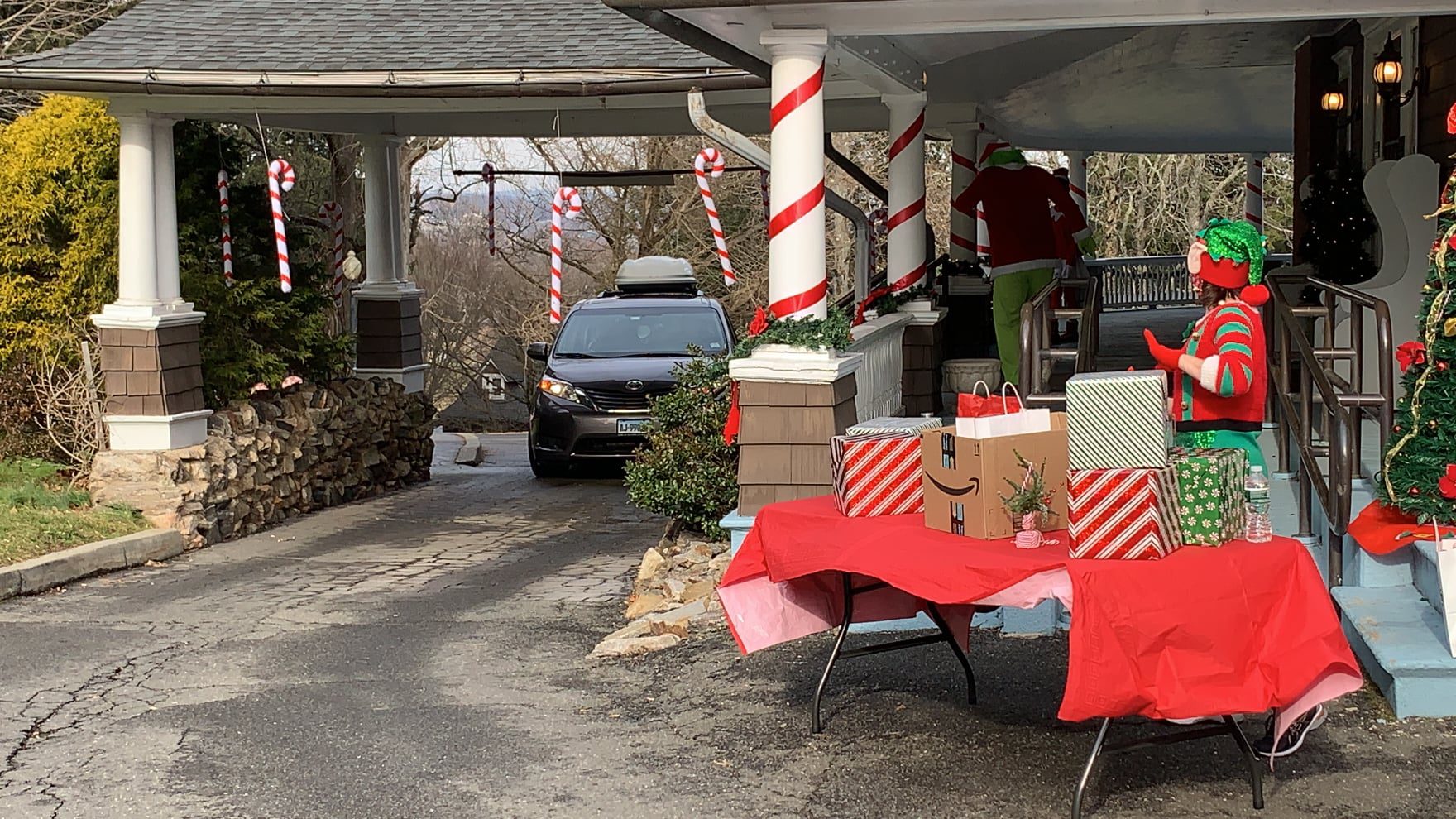 Candy Cane Hunt Drive Thru car driving up to get gift from elf